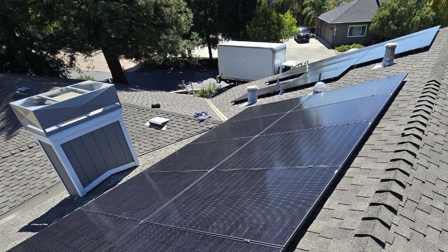 Solar panels and HVAC equipment installed on a residential roof