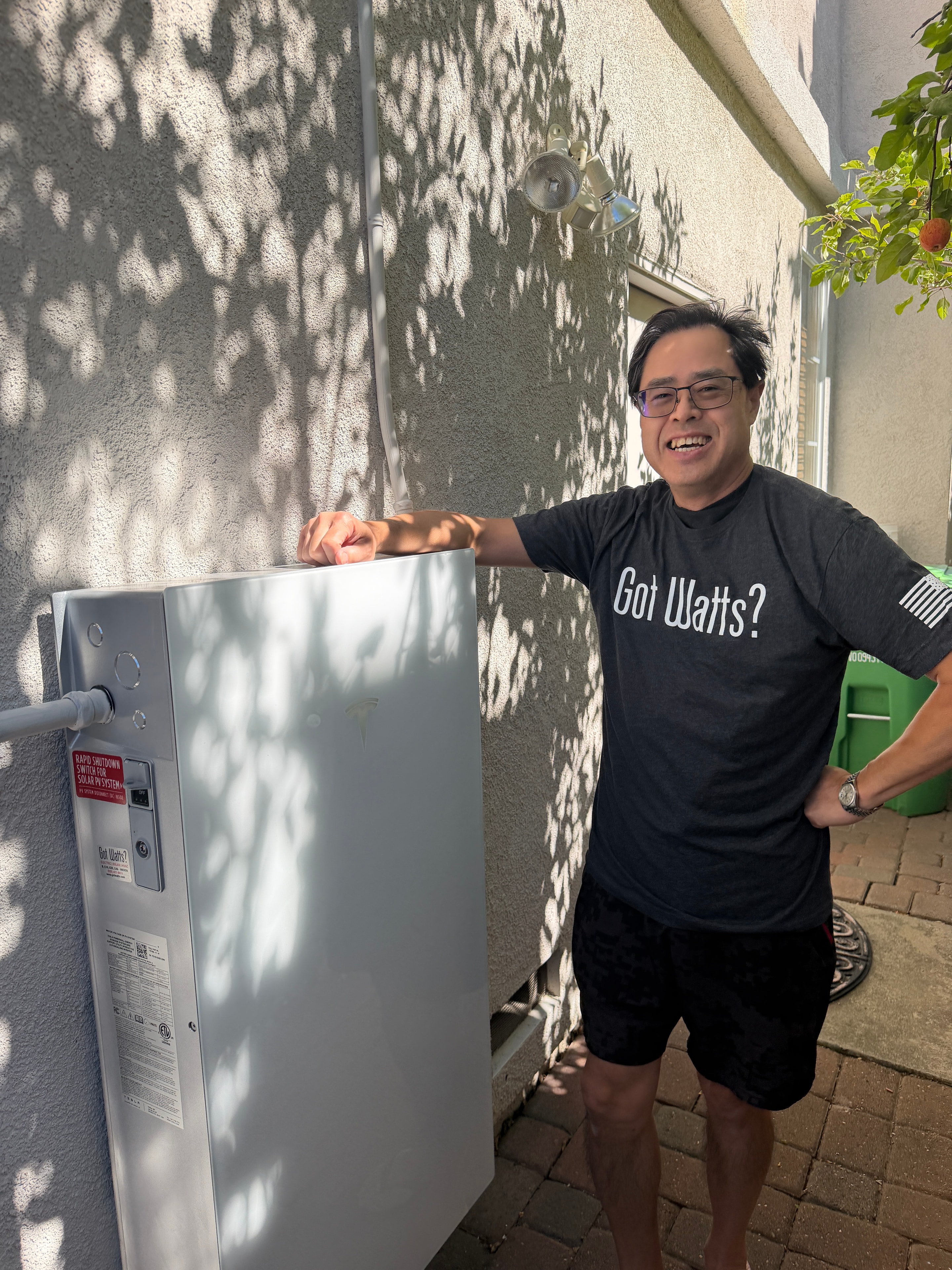 A GOT WATTS client posing with his newly installed home battery unit