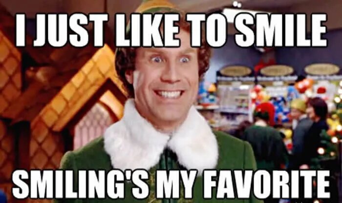 A man in elf costume with the words " just like to smile " and " elling 's my favorite."