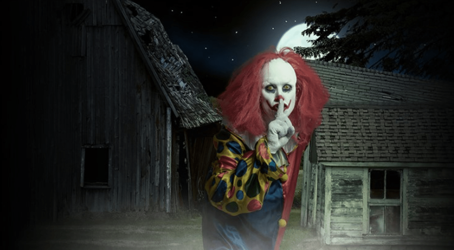 A clown with red hair and a white face