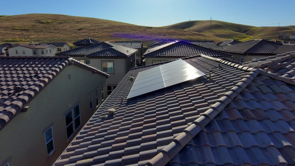 A solar panel on the roof of a house.