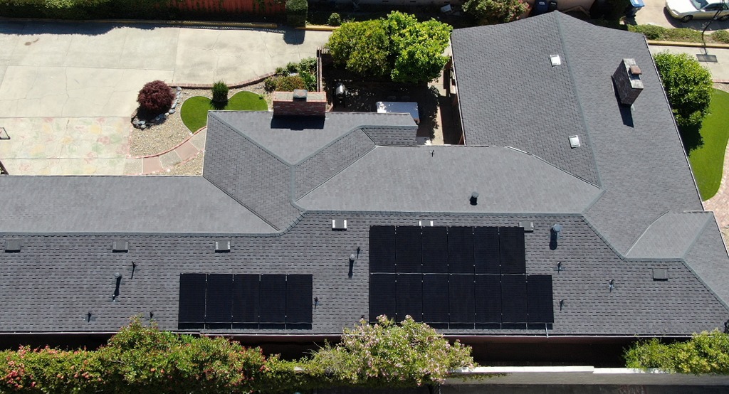 A large house with solar panels on the roof.